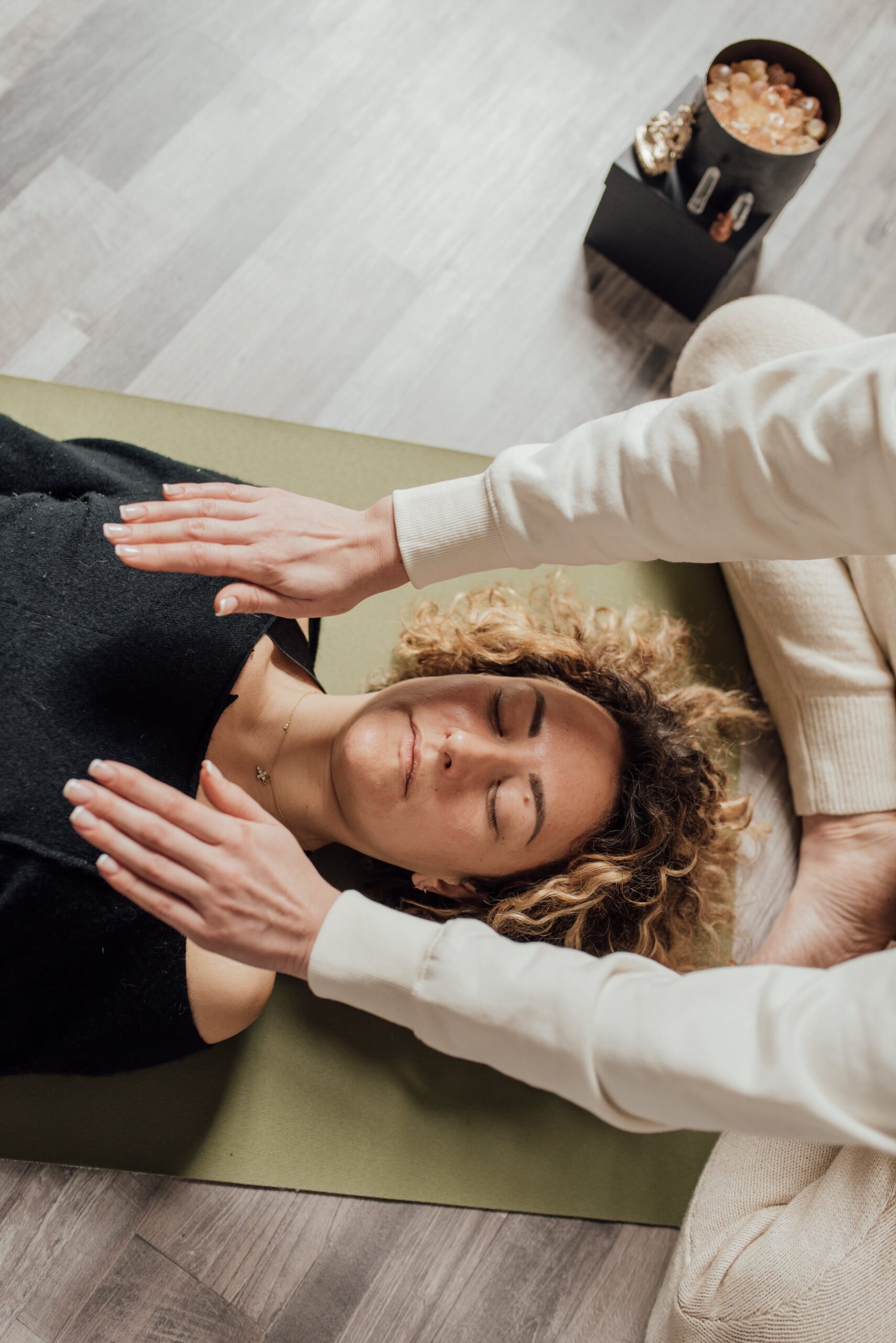 woman lying on the floor practicing reiki